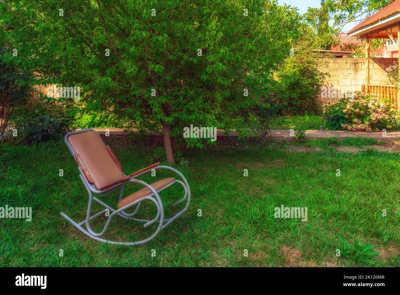 Rocking chair in the garden of a country house Stock Photo - Alamy