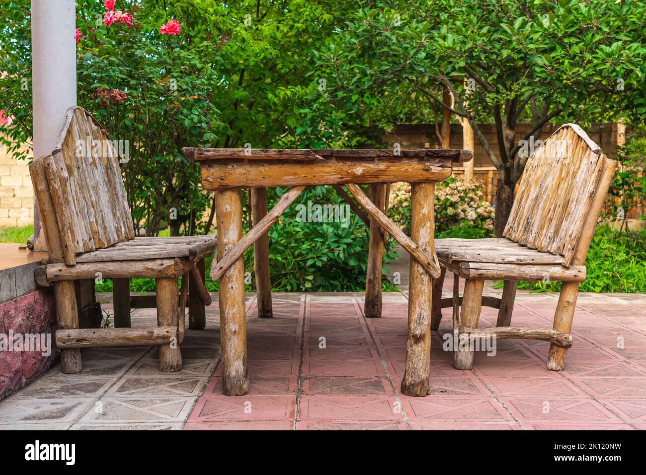 Old homemade wooden table with a bench Stock Photo