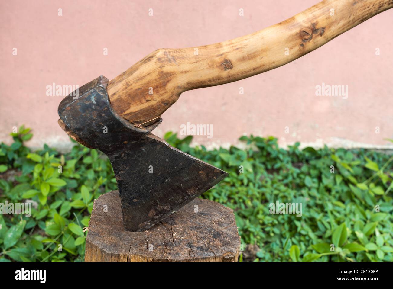 Antique sharp ax in a log Stock Photo