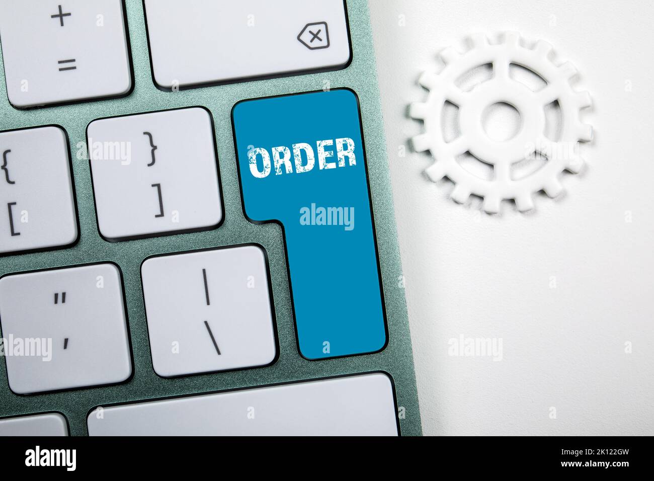 Order. White computer keyboard with blue button. Stock Photo