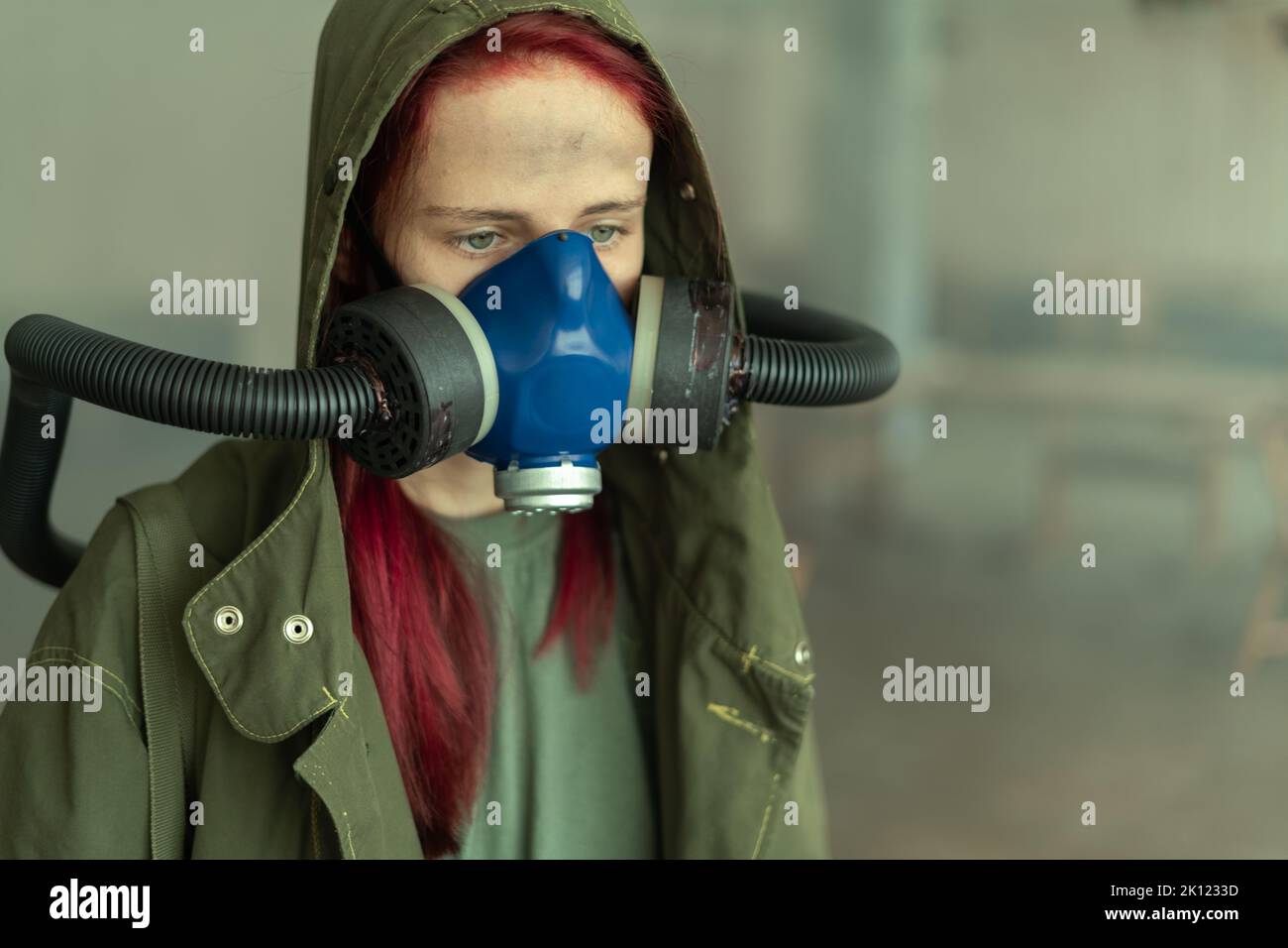Post apocalypse female survivor in oxygen mask. Stock Photo