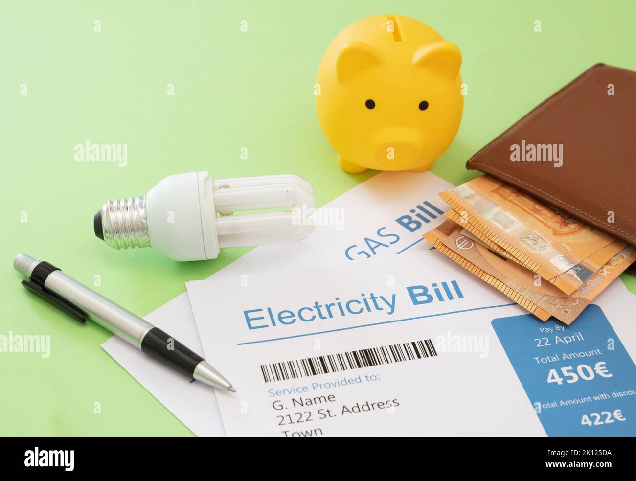 Electricity and gas bills, euro banknotes, light bulb and piggy bank