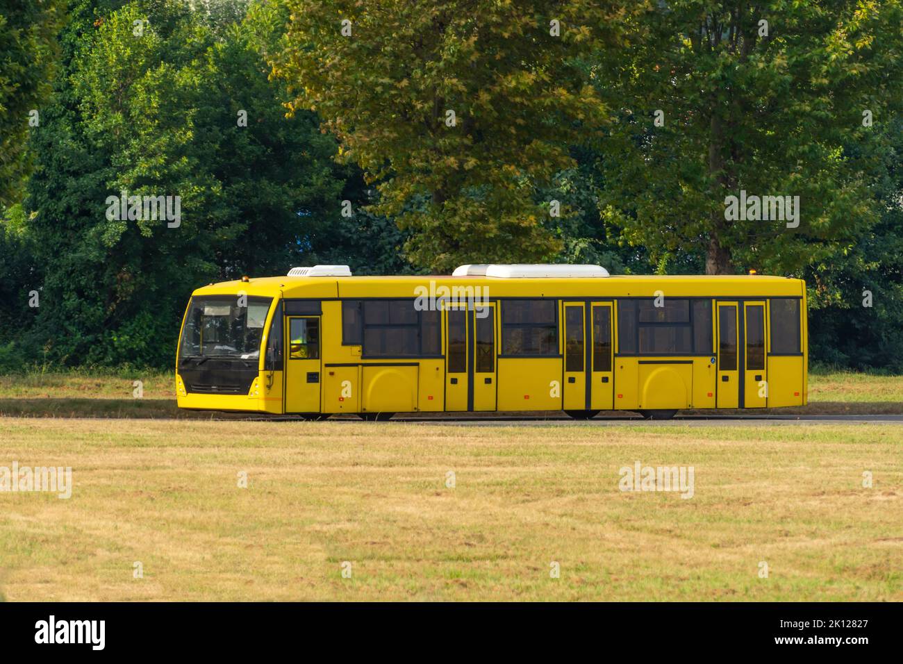 Yellow shuttle bus to transport people at the airport to the flight Stock Photo