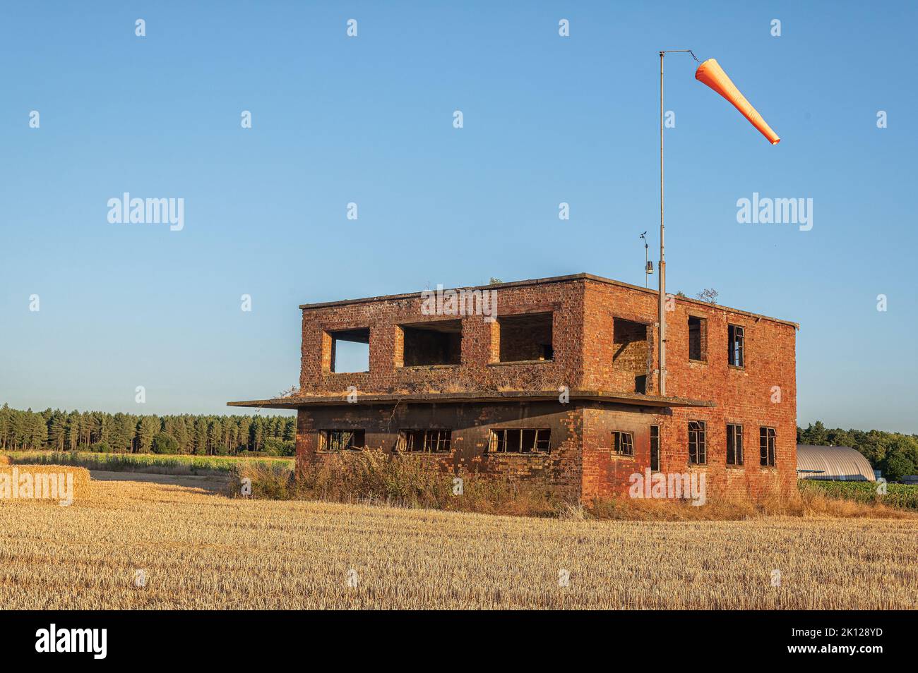 Old WW2 RAF control tower with modern windsock. Found on the still active Little Snoring airfield North Norfolk, UK Stock Photo