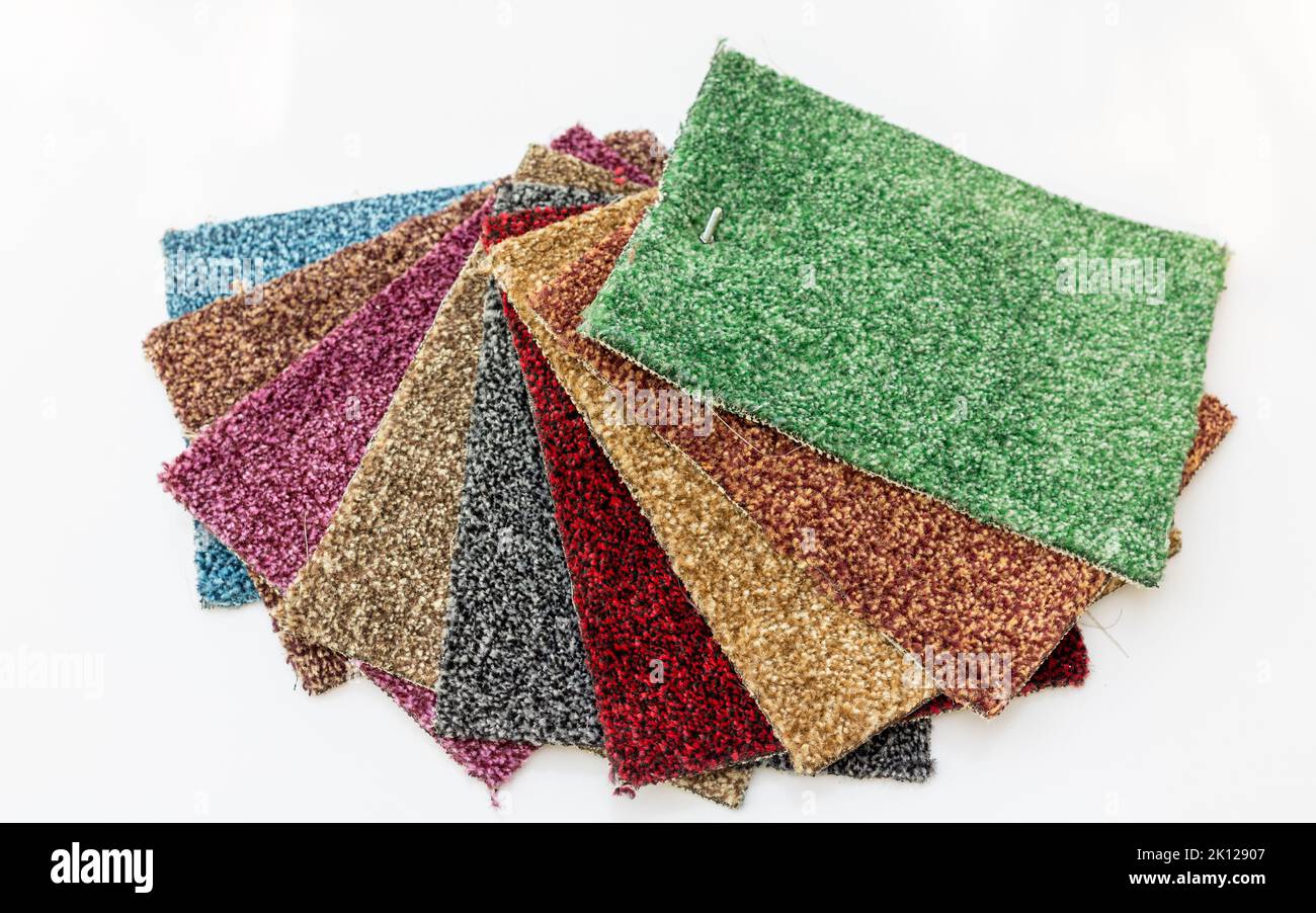Different colors of carpet for display in a shop on isolated white ...