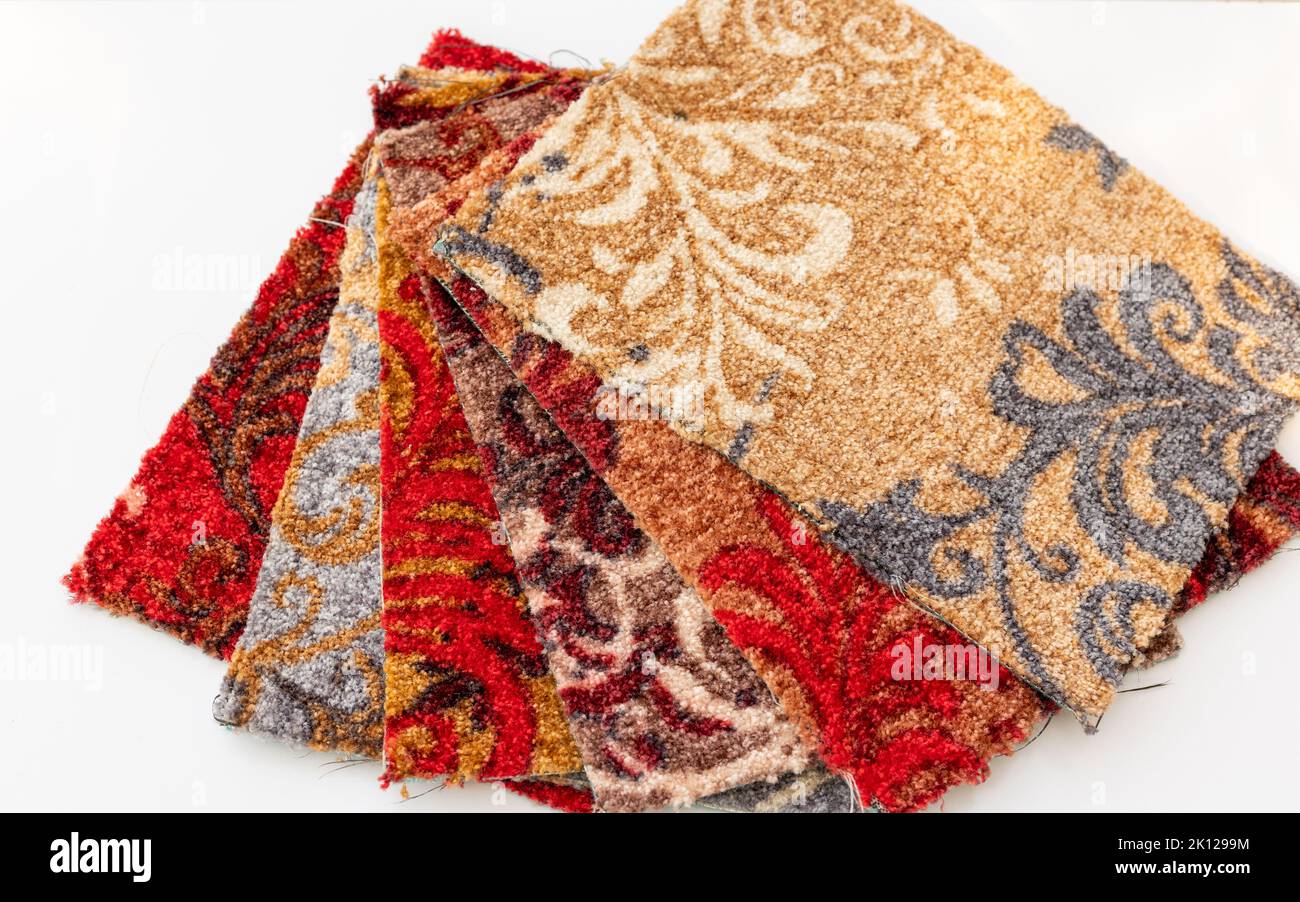 Multi colors carpets pieces display for sale in the store on white