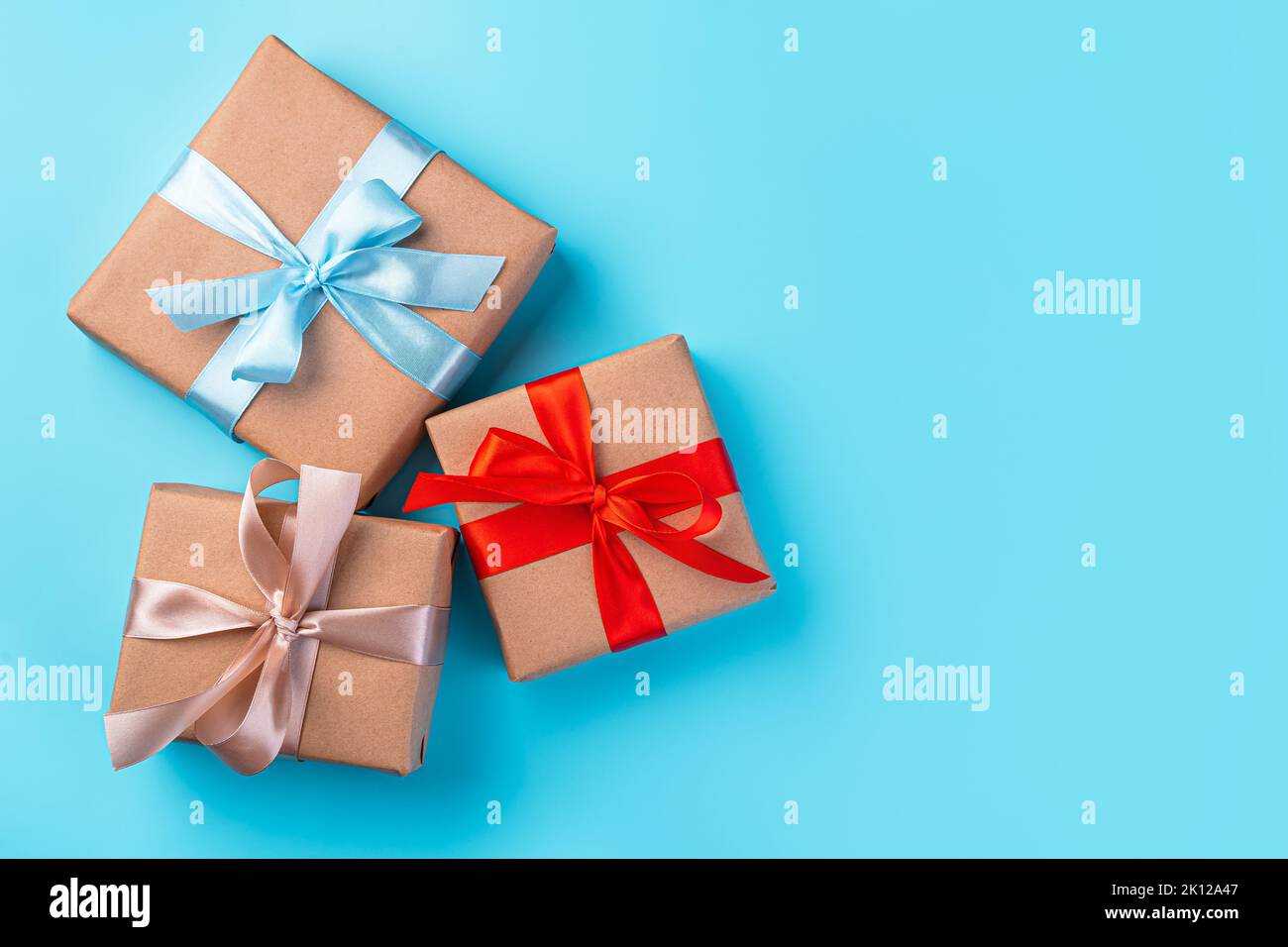Gift boxes with colored ribbons on a blue background. Stock Photo