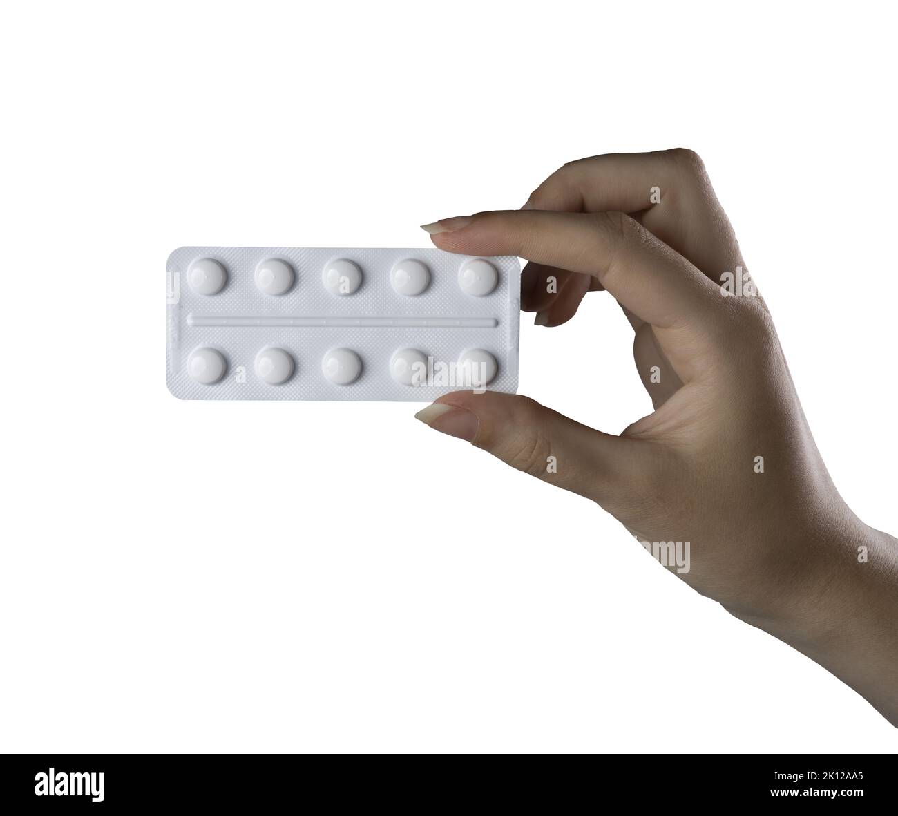 a blister pack of pills in the female hand on a white background Stock Photo
