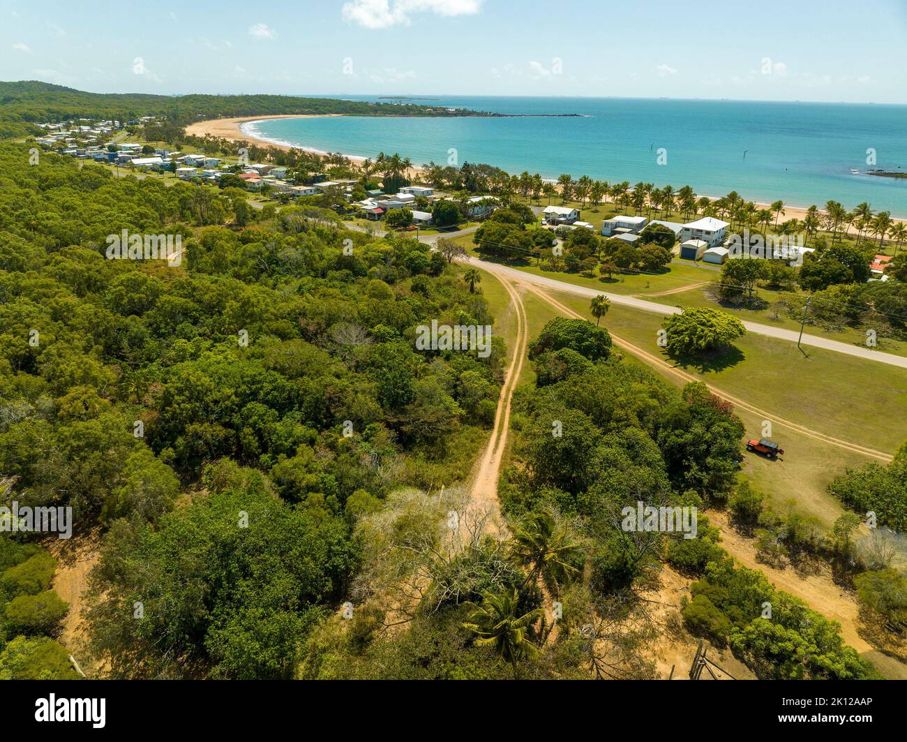 The coastline of Grasstree Beach Queensland Australia with homes on the