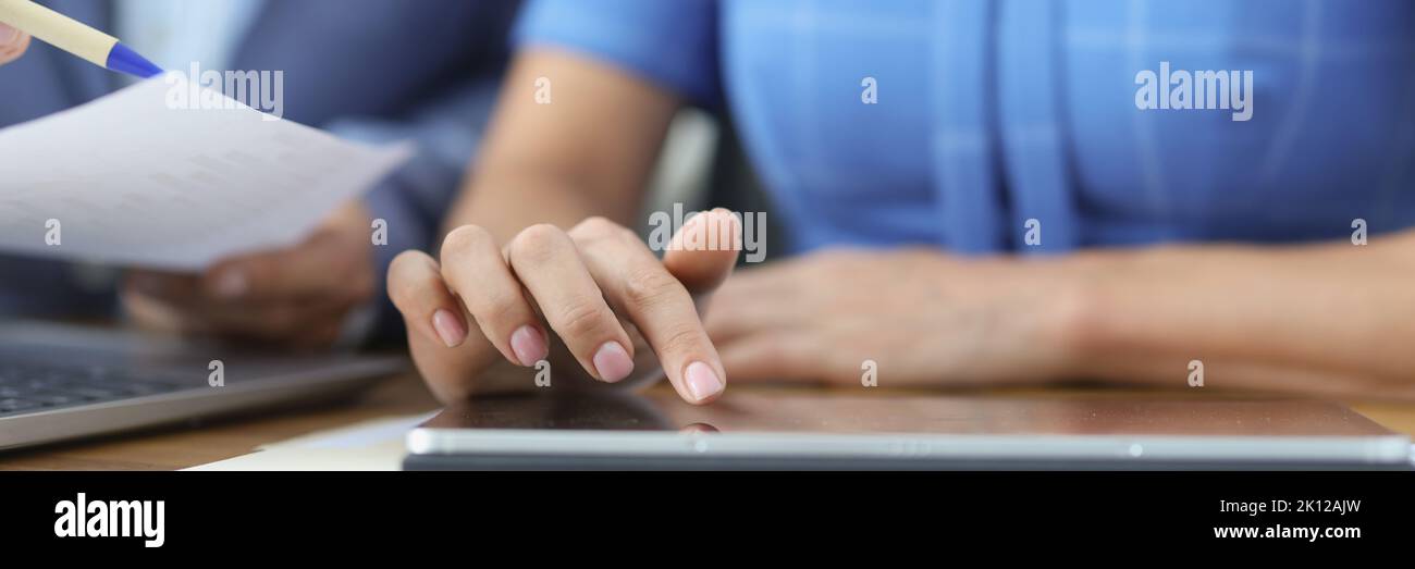 Business people talking using digital tablet sitting at office table Stock Photo