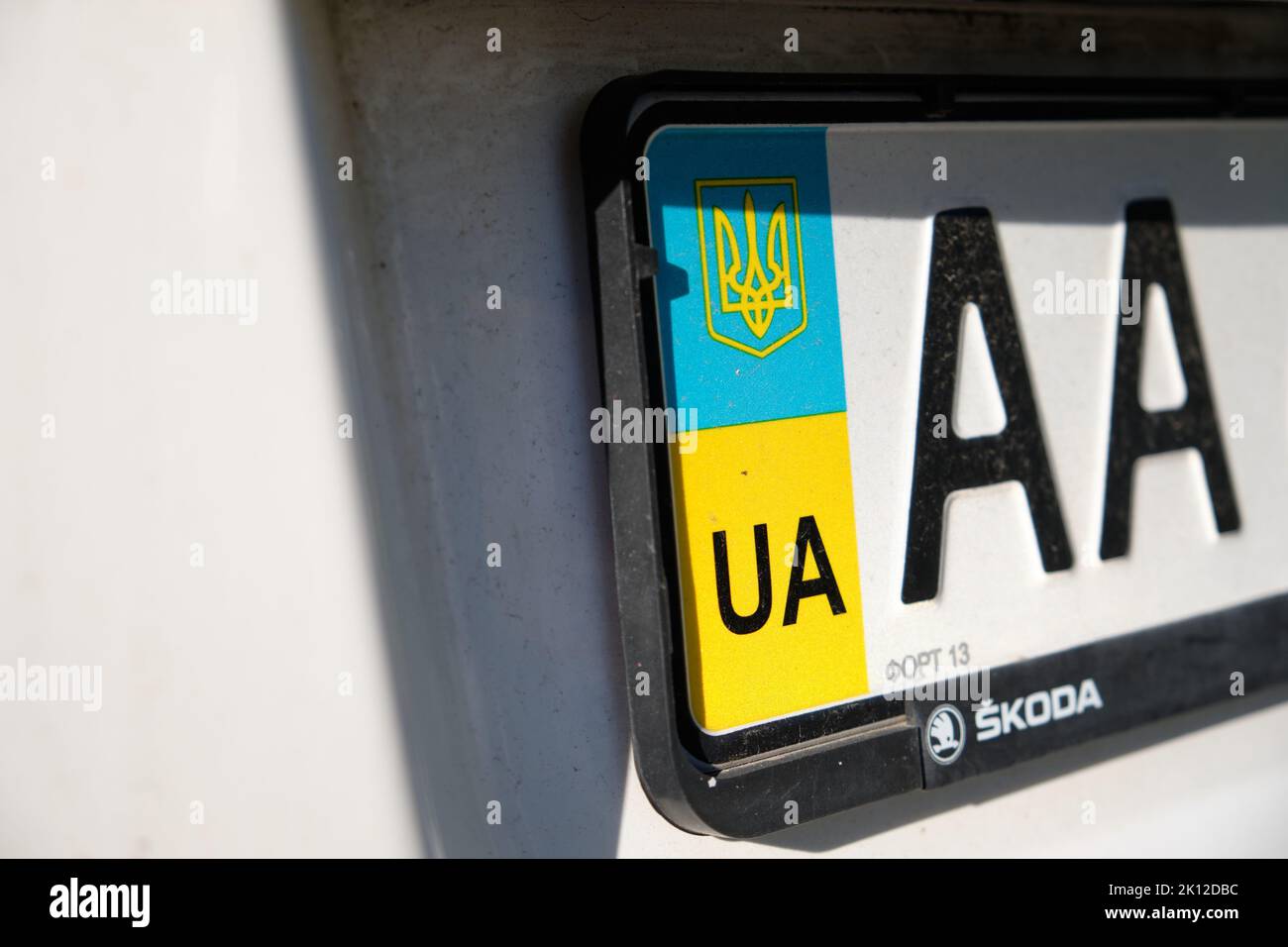 Nuremberg, Germany - 23 August, 2022: Closeup of the ukrainian number plate on a white Skoda car with the national colors blue and yellow and the coat Stock Photo