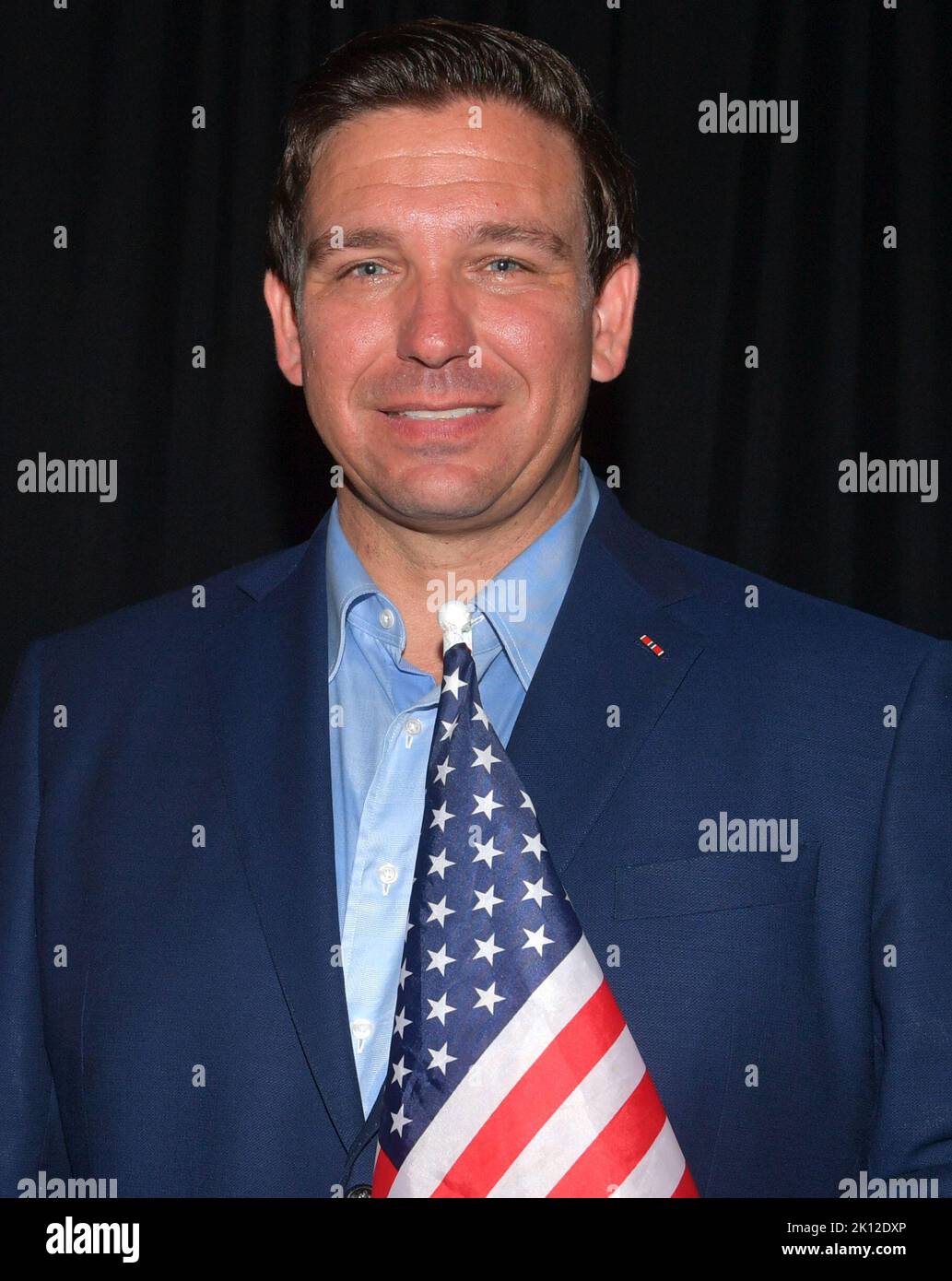 BOCA RATON, FL - NOVEMBER 04: (EXCLUSIVE COVERAGE)  Ron DeSantis, and his wife Casey DeSantis along with Attorney General Pam Bondi pose back stage with the America Flag in Boca Raton on November 4, 2018 in Boca Raton, Florida.  People:  Ron DeSantis, Casey DeSantis Stock Photo