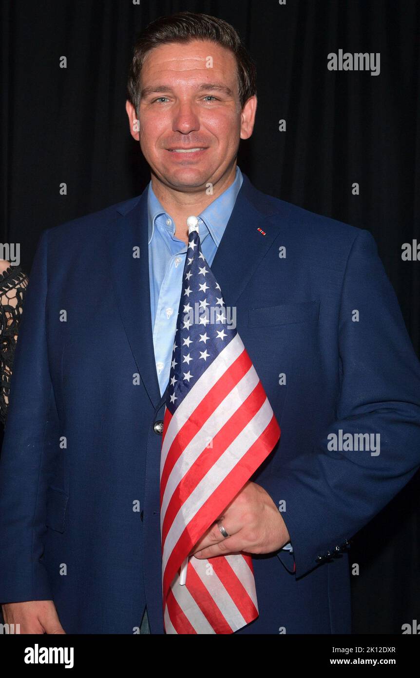 BOCA RATON, FL - NOVEMBER 04: (EXCLUSIVE COVERAGE)  Ron DeSantis, and his wife Casey DeSantis along with Attorney General Pam Bondi pose back stage with the America Flag in Boca Raton on November 4, 2018 in Boca Raton, Florida.  People:  Ron DeSantis, Casey DeSantis Stock Photo