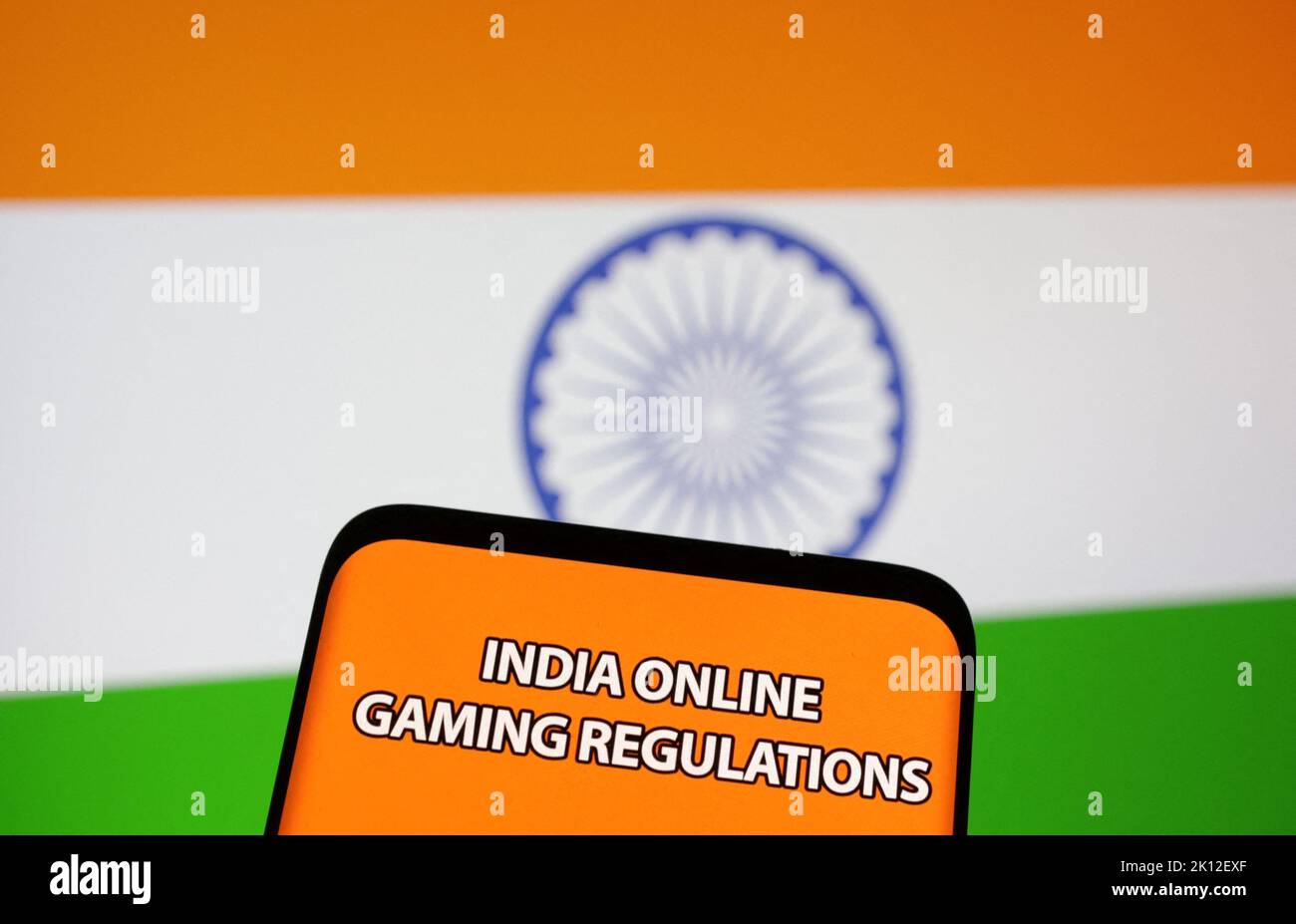 The words 'India online gaming regulations' are displayed in front of an Indian flag in this Illustration taken September 14, 2022. REUTERS/Dado Ruvic/Illustration Stock Photo