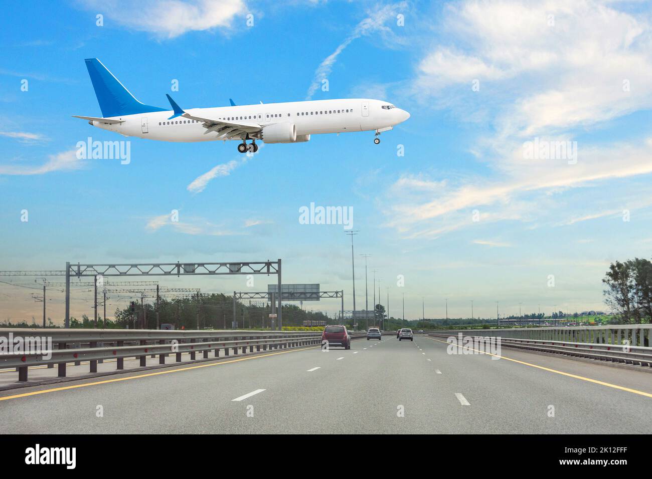 Low-flying aircraft over the expressway before landing at the airport Stock Photo