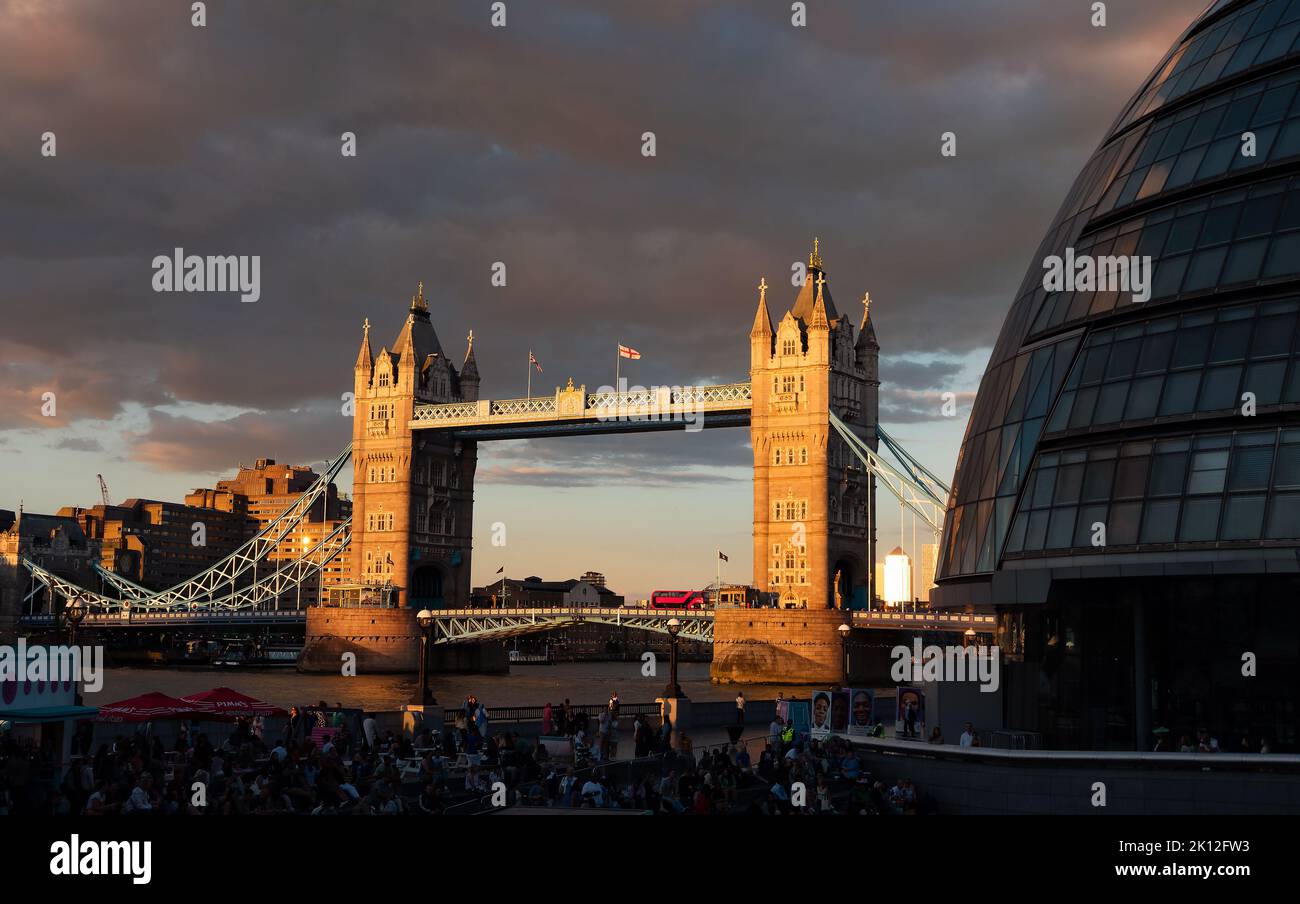 London, England Uk - August 5, 2022: Panorama of the More London Riverside and people enjoying a music festival on the Thames riverside at sunset Stock Photo