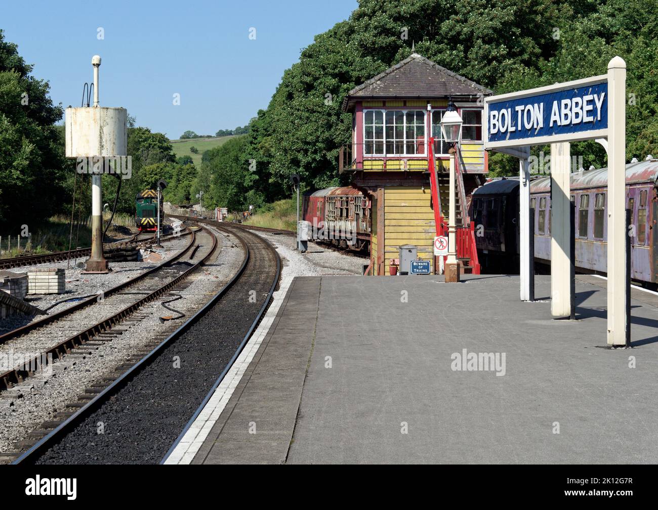 View up the line from the platform at Bolton Abbey station on the Embsay & Bolton Abbey heritage railway showing signal box and water tank. Stock Photo
