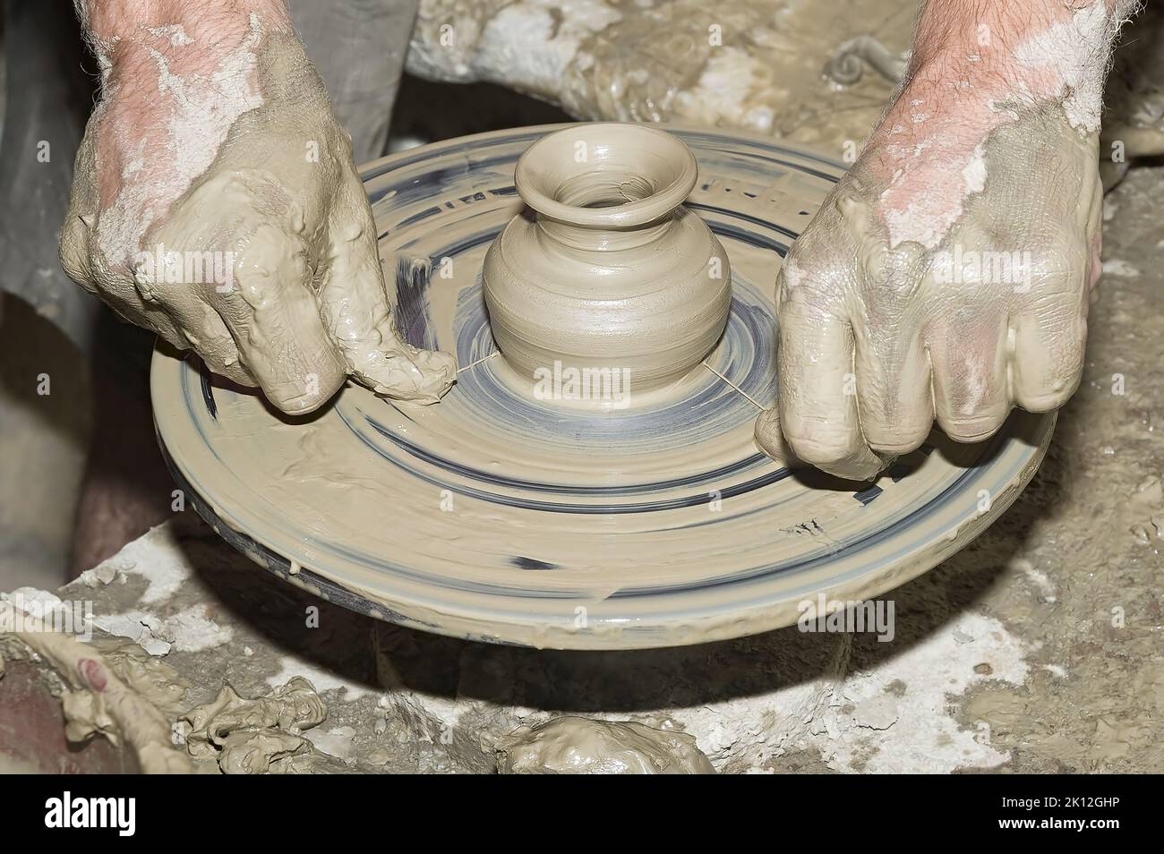 Potter's work on old potter's wheel Stock Photo Alamy