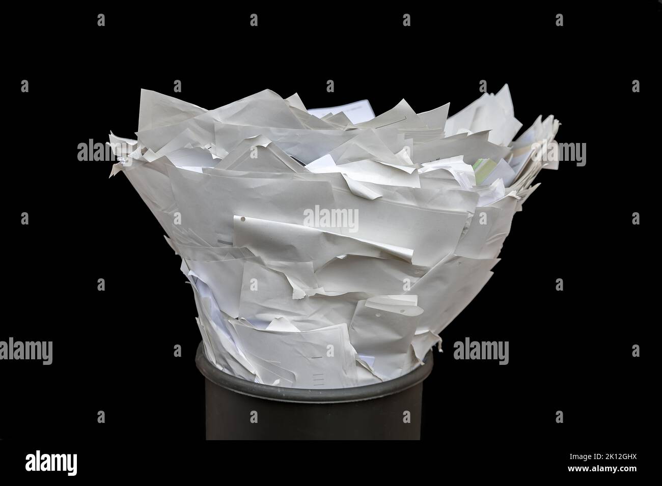 Full trash in a detailed shot against a black background Stock Photo