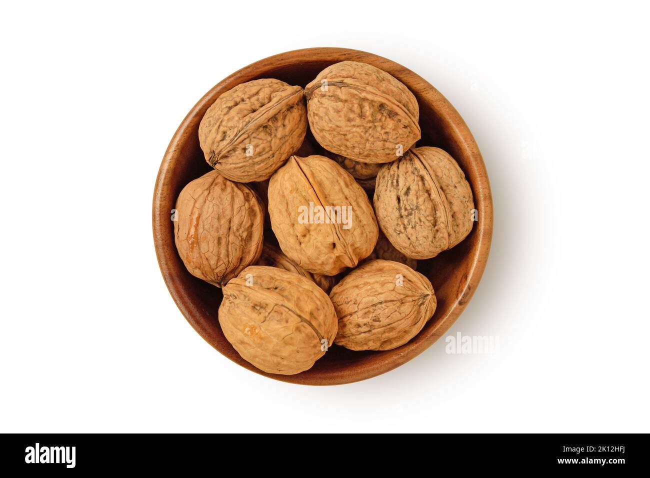 Shelled walnuts in wooden bowl on white background Stock Photo