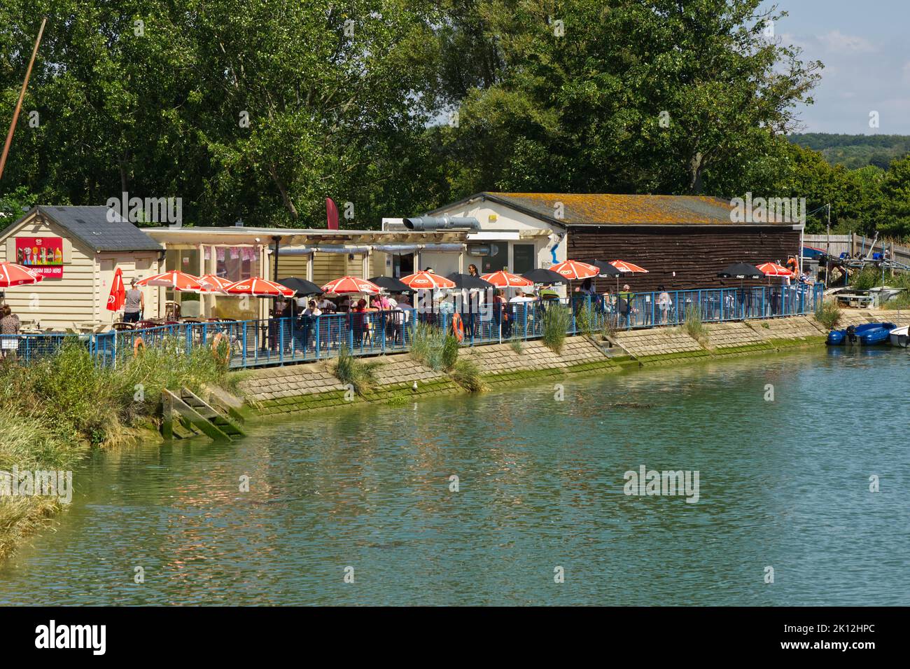 Terrace cafe on riverside at Arundel in West Sussex, England. People enjoying food and drink. Stock Photo