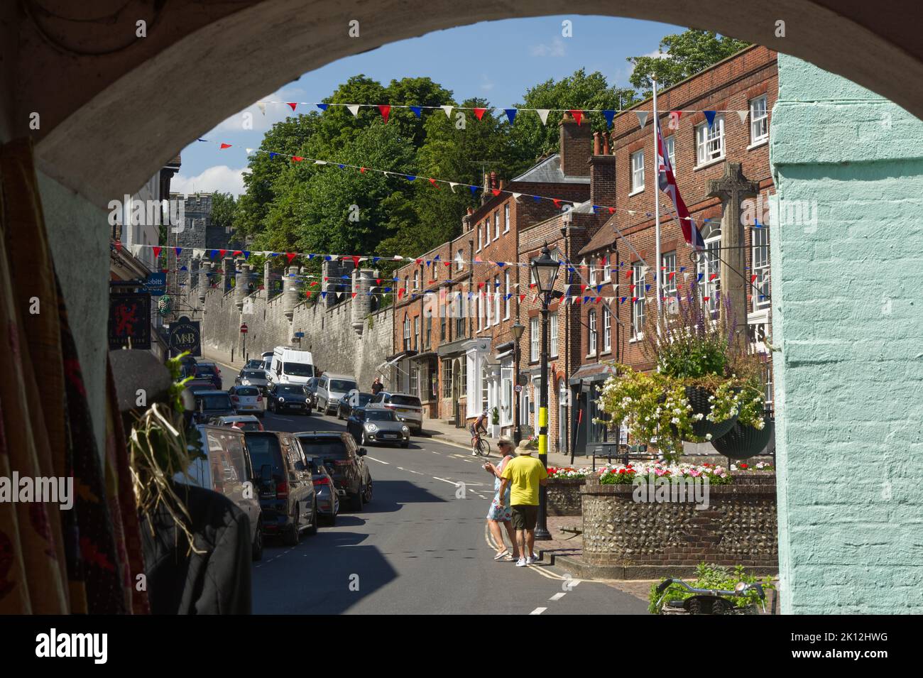 View up the High Street in Arundel, West Sussex, England. With people walking around. Stock Photo