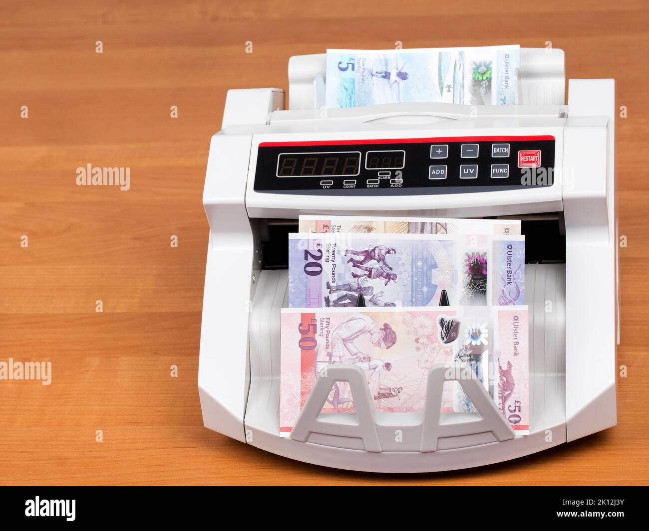 Northern Ireland’s money - Pounds  in a counting machine Stock Photo