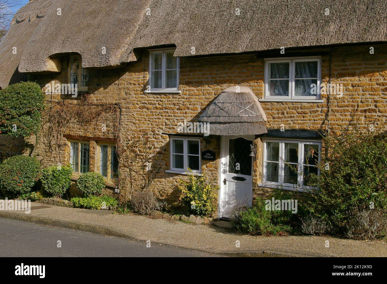 Pretty stone built thatched cottage in the village of Boughton, Northamptonshire, UK Stock Photo