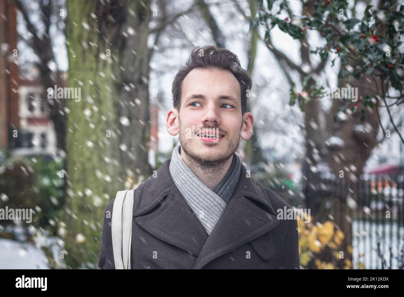 Portrait of a handsome young man in winter snow Stock Photo