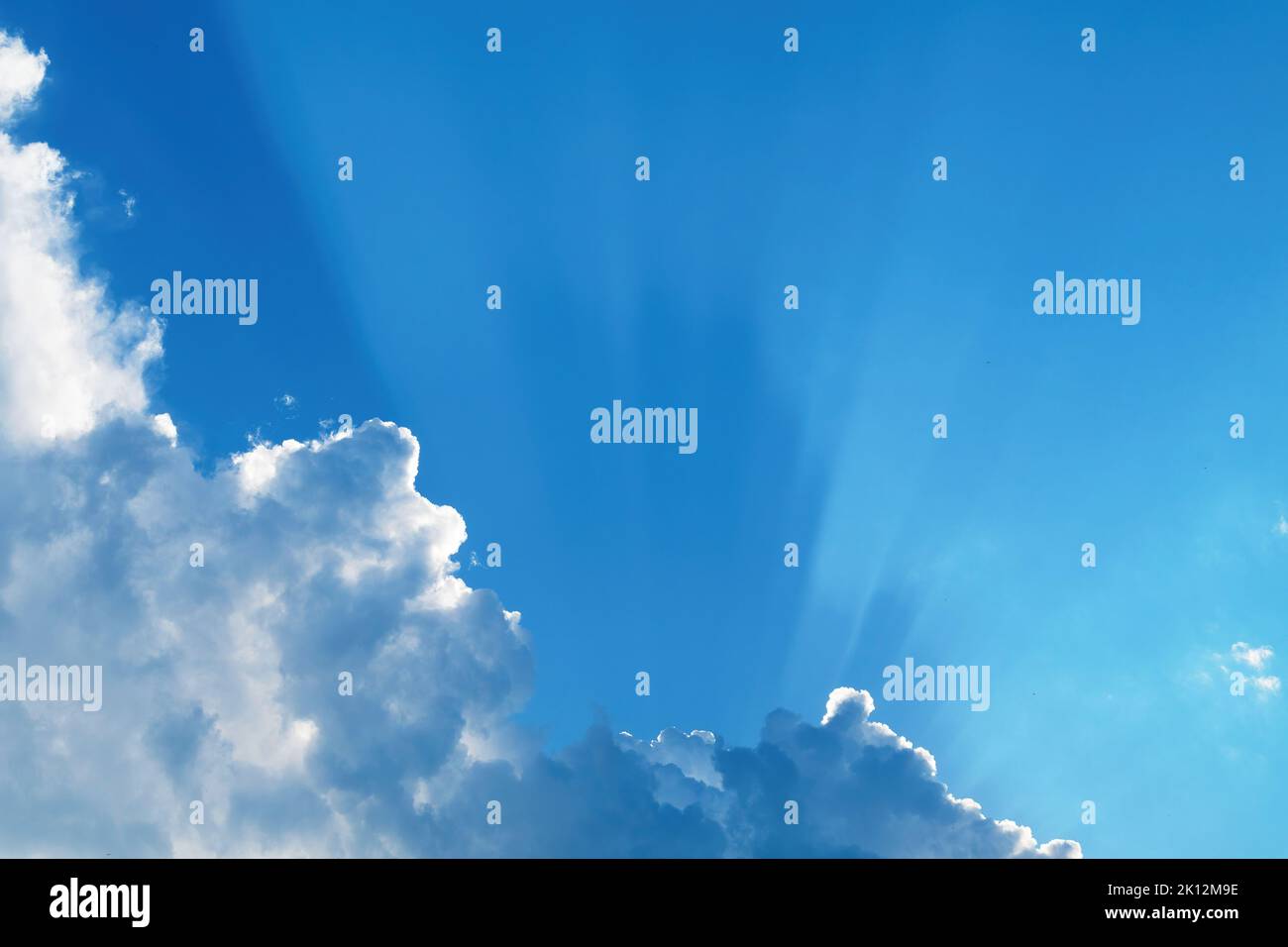 Heavenly clouds, white clouds with shadows cast by the sun through the haze on blue sky Stock Photo