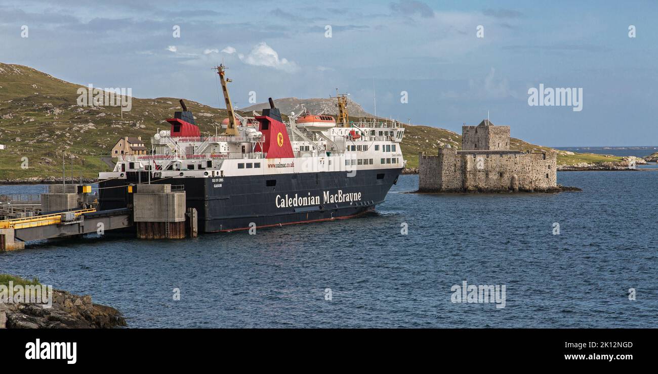 CalMac Ferry moored beneath Kisimul Castle, Castlebay, Barra, Isle of Barra, Hebrides, Outer Hebrides, Western Isles, Scotland, United Kingdom Stock Photo