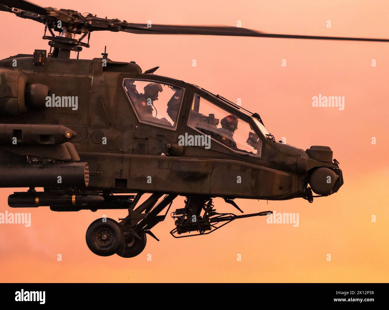 Boeing AH-64 Appache attack helicopter in flight during the Sanicole Sunset Air Show. Belgium - September 10, 2022 Stock Photo