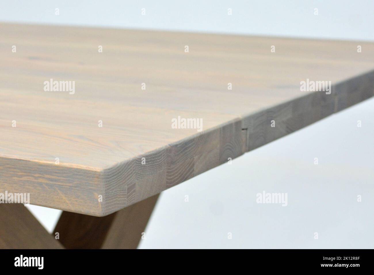 Wooden dinner table surface. Natural wood furniture close view