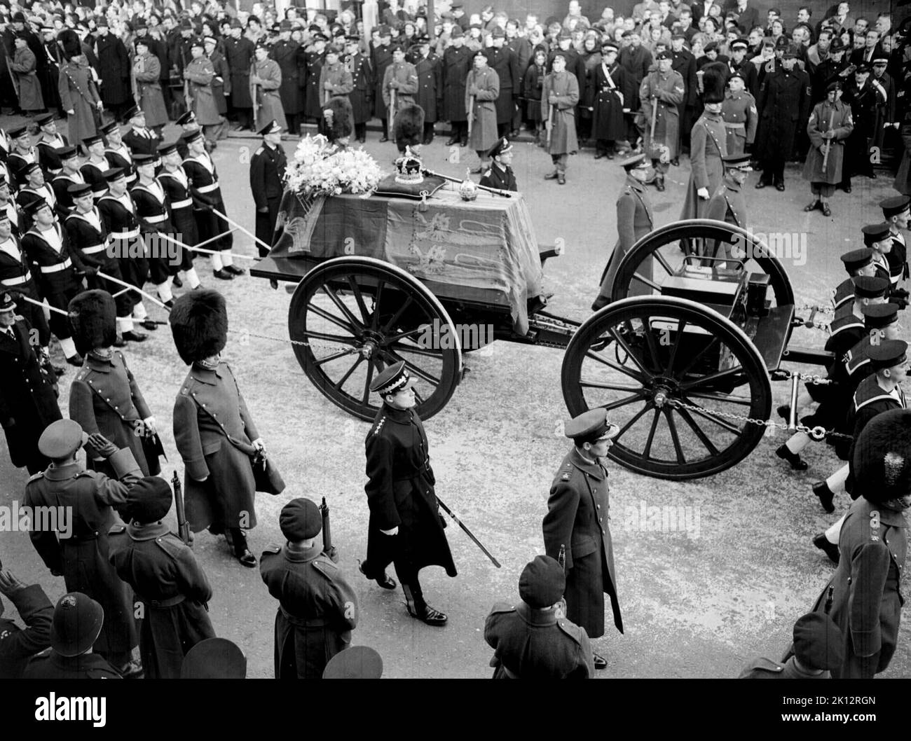 File photo dated 15/2/1952 of the final journey of King George VI, when his coffin was taken in procession from Windsor Railway Station to the funeral service in St. George's Chapel. Non-commissioned sailors, Naval ratings, traditionally pull the gun carriage bearing the sovereign's coffin through the streets using ropes, a practice which will take place during the Queen's funeral. The custom was adopted in 1901 at Victoria's funeral when the splinter bar of the gun carriage broke as her coffin, weighing nearly half a ton, was lifted into place and the horses began to move. The naval guard of  Stock Photo