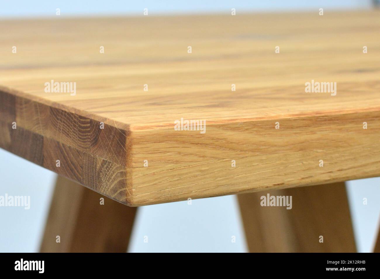 Wooden dinner table surface. Natural wood furniture close view