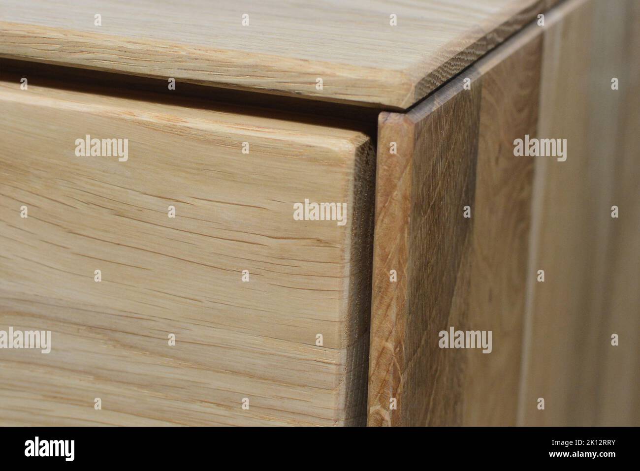 Wooden dresser corner and surface. Natural wood close view photo