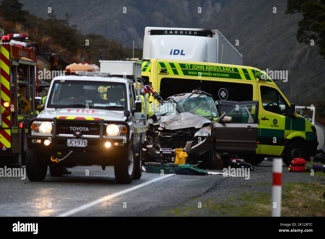 ARTHUR'S PASS, NEW ZEALAND, SEPTEMBER 5, 2022: Emergency teams respond to a single car accident after the driver lost control on black ice on State Highway 73 while crossing the Southern Alps. Grainy image shot in poor morning light. Stock Photo