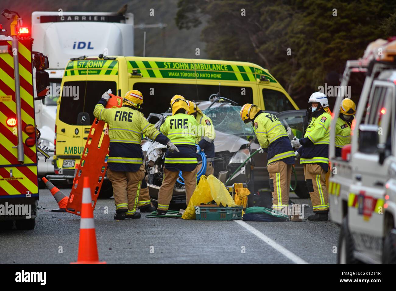 ARTHUR'S PASS, NEW ZEALAND, SEPTEMBER 5, 2022: Emergency teams respond to a single car accident after the driver lost control on black ice on State Highway 73 while crossing the Southern Alps. Grainy image shot in poor morning light. Stock Photo