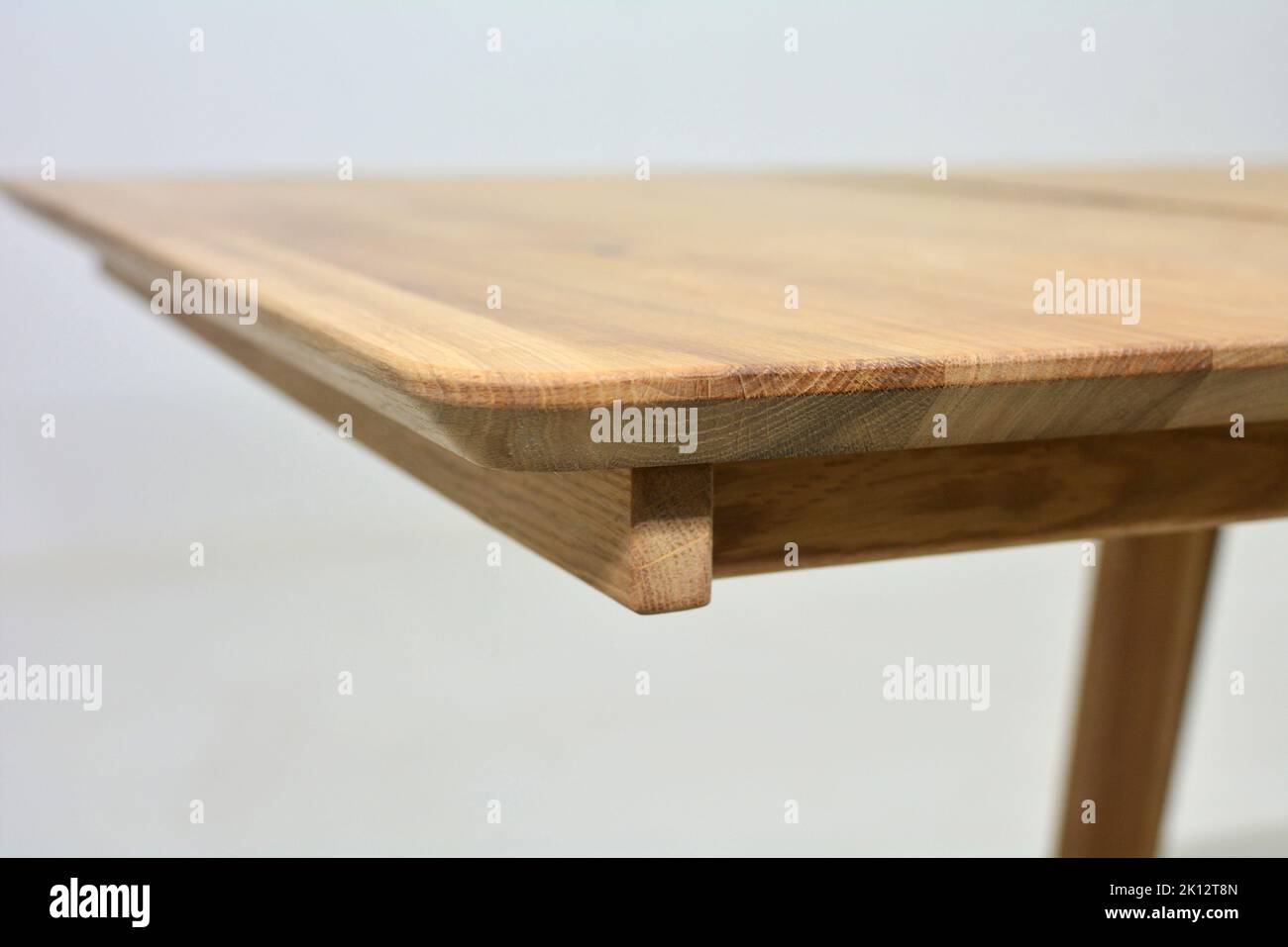 Wooden dinner table surface. Natural wood furniture close view. Solid