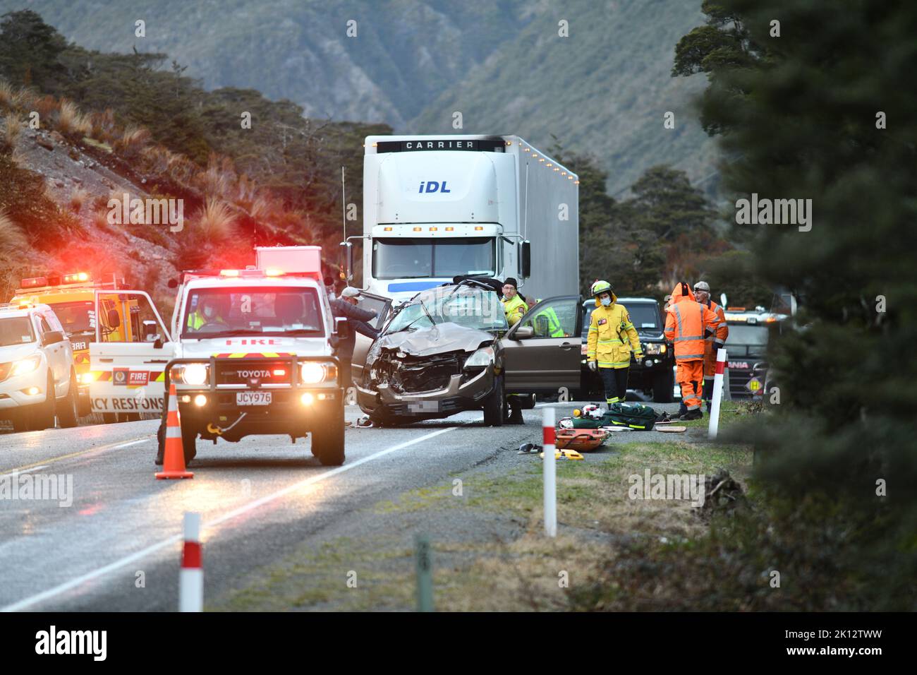 ARTHUR'S PASS, NEW ZEALAND, SEPTEMBER 5, 2022: Emergency teams respond to a single car accident after the driver lost control on black ice on State Highway 73 while crossing the Southern Alps. Grainy image shot in poor morning light. Stock Photo