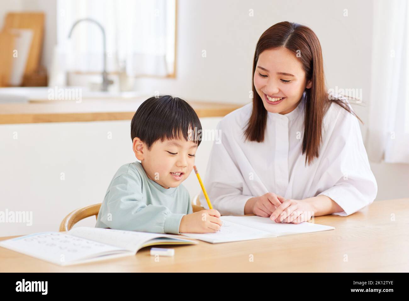 Japanese kid and mother studying at home Stock Photo