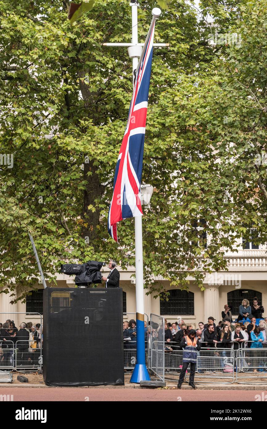 On the Mall in central London, a television cameraman waits for the procession bearing the remains of the late Queen Elizabeth II from Buckingham Palace to Westminster Hall for the lying-in-state Stock Photo