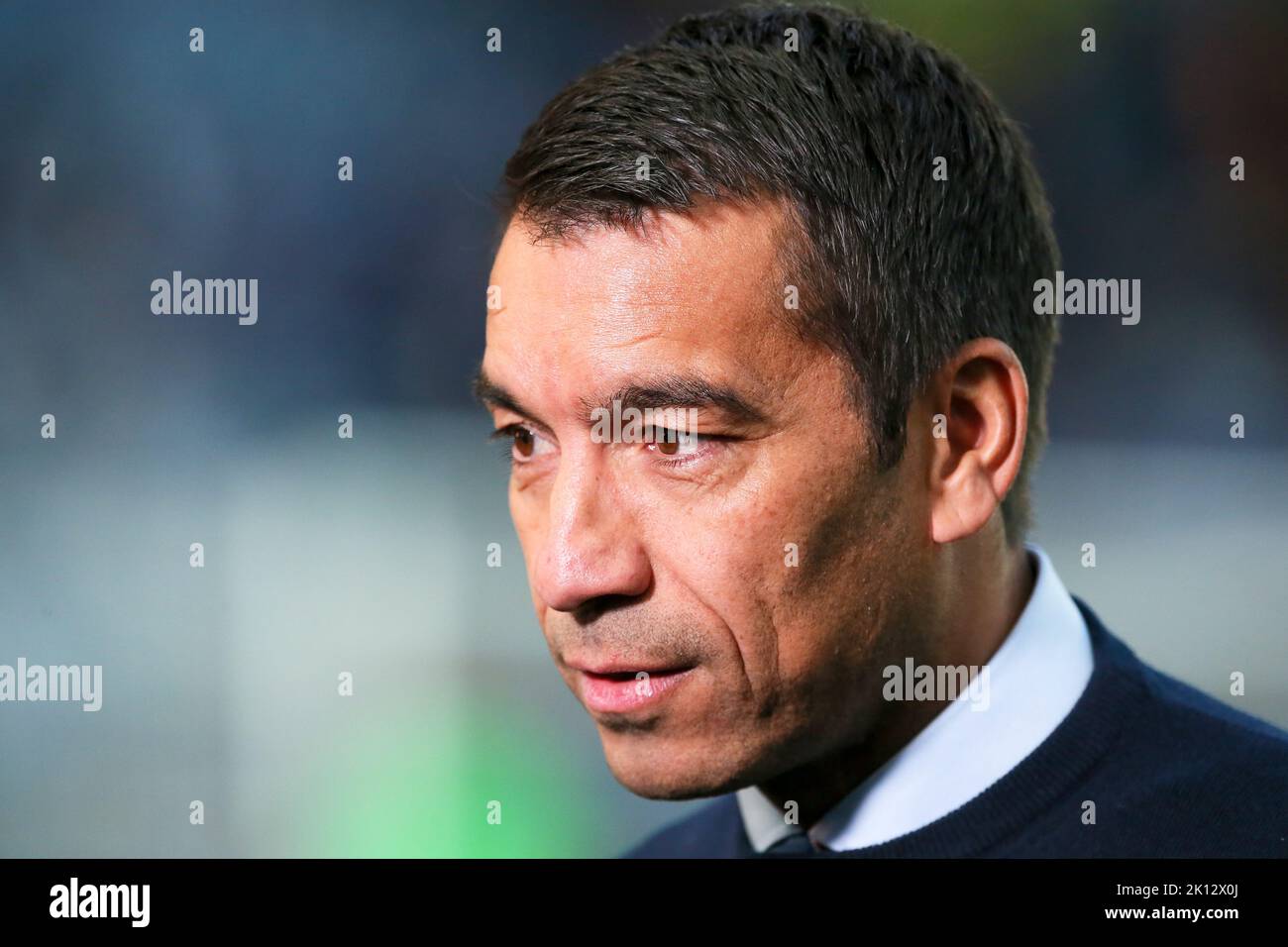 Giovanni Van Bronckhorst, manager of Rangers FC, being interviewed at Ibrox Park football stadium, Glasgow, Scotland before the UEFA Champions League Stock Photo