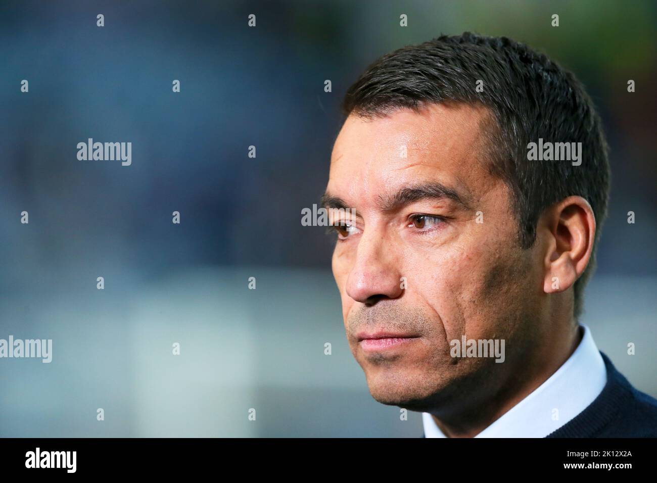Giovanni Van Bronckhorst, manager of Rangers FC, being interviewed at Ibrox Park football stadium, Glasgow, Scotland before the UEFA Champions League Stock Photo
