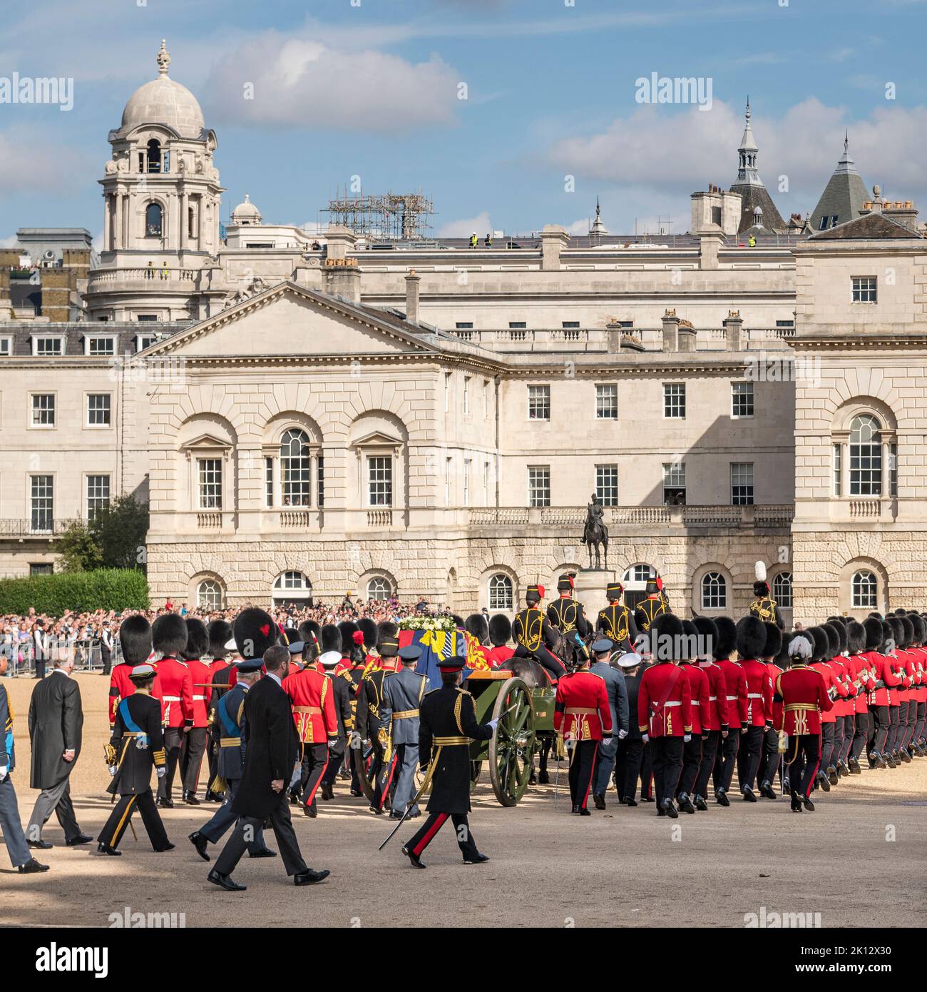 The procession bearing the body of the late Queen Elizabeth II from Buckingham Palace to Westminster Hall for the lying-in-state, seen here crossing Horse Guards Parade. The coffin, covered in the Royal Standard, rests on a gun carriage pulled by a team from the Royal Horse Artillery. The Queen's children, (l-r) Prince Andrew, Princess Anne, and King Charles III, are walking behind the coffin Stock Photo