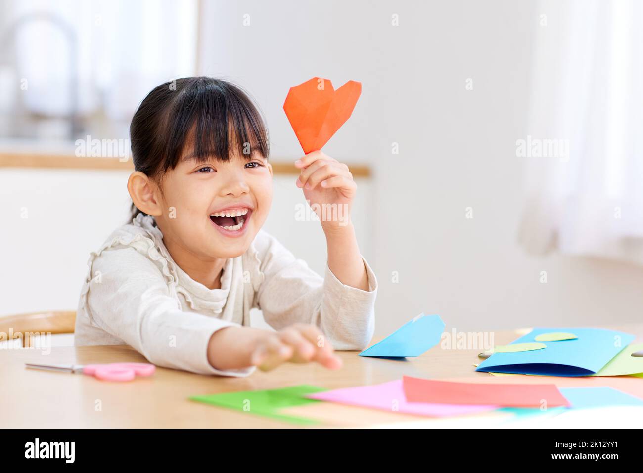 Japanese kid playing with origami at home Stock Photo