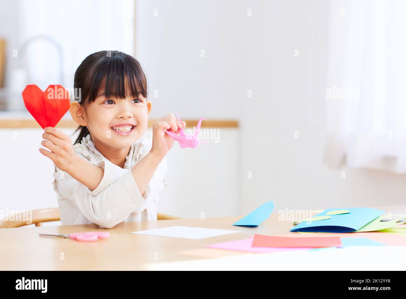 Japanese kid playing with origami at home Stock Photo - Alamy