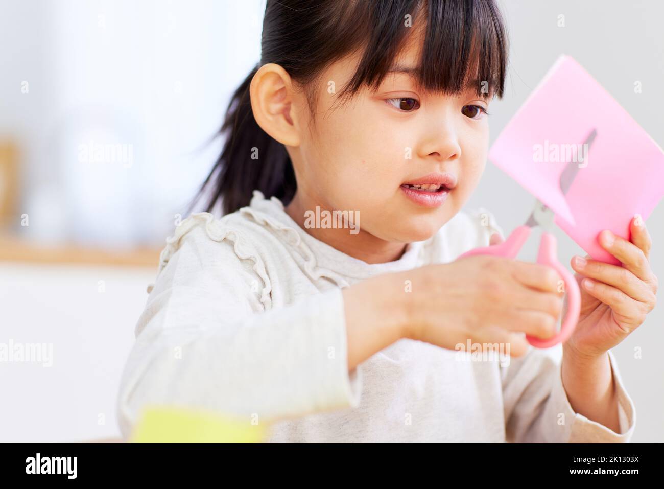 Japanese kid playing with origami at home Stock Photo - Alamy