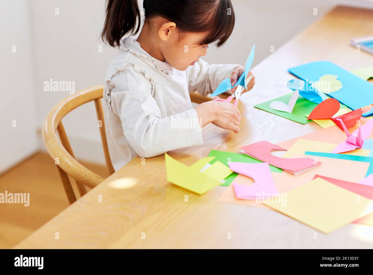 Japanese kid playing with origami at home Stock Photo - Alamy