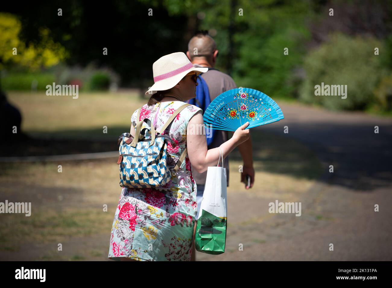 A woman with a fan as people in the city of York, North Yorkshire endure the hottest day on record as the temperature in the UK passes 40 degrees Fare Stock Photo